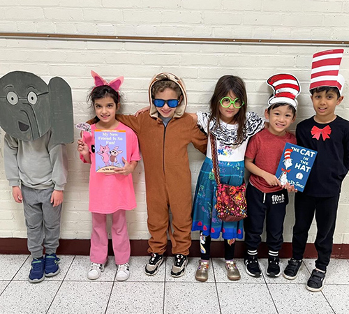Group of students dressed book characters in a line