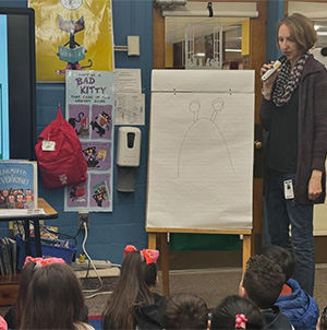 Megham McCarthy speaking to students with a microphone