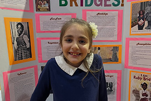 Student in front of their Ruby Bridges information presentation board