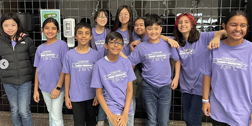 Ten students in purple tee shirts and jeans