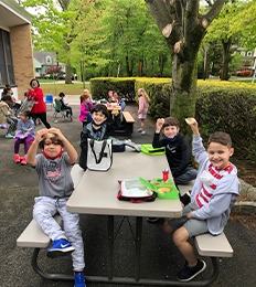 Second grade students eating outside