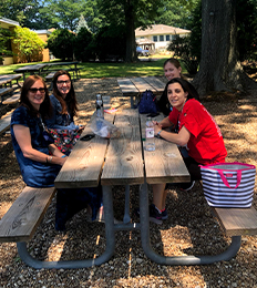 teachers eating under the trees in the ELC